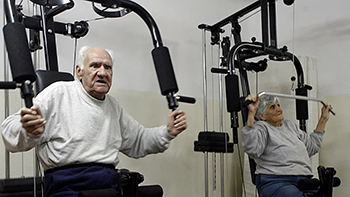 Old Man and Wife on Exercise Equipment