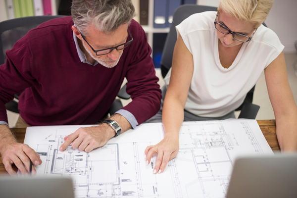 Older Couple Reviewing House Plans